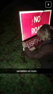 Angie Abingdon altering road sign in Gloucestershire during pothole protest